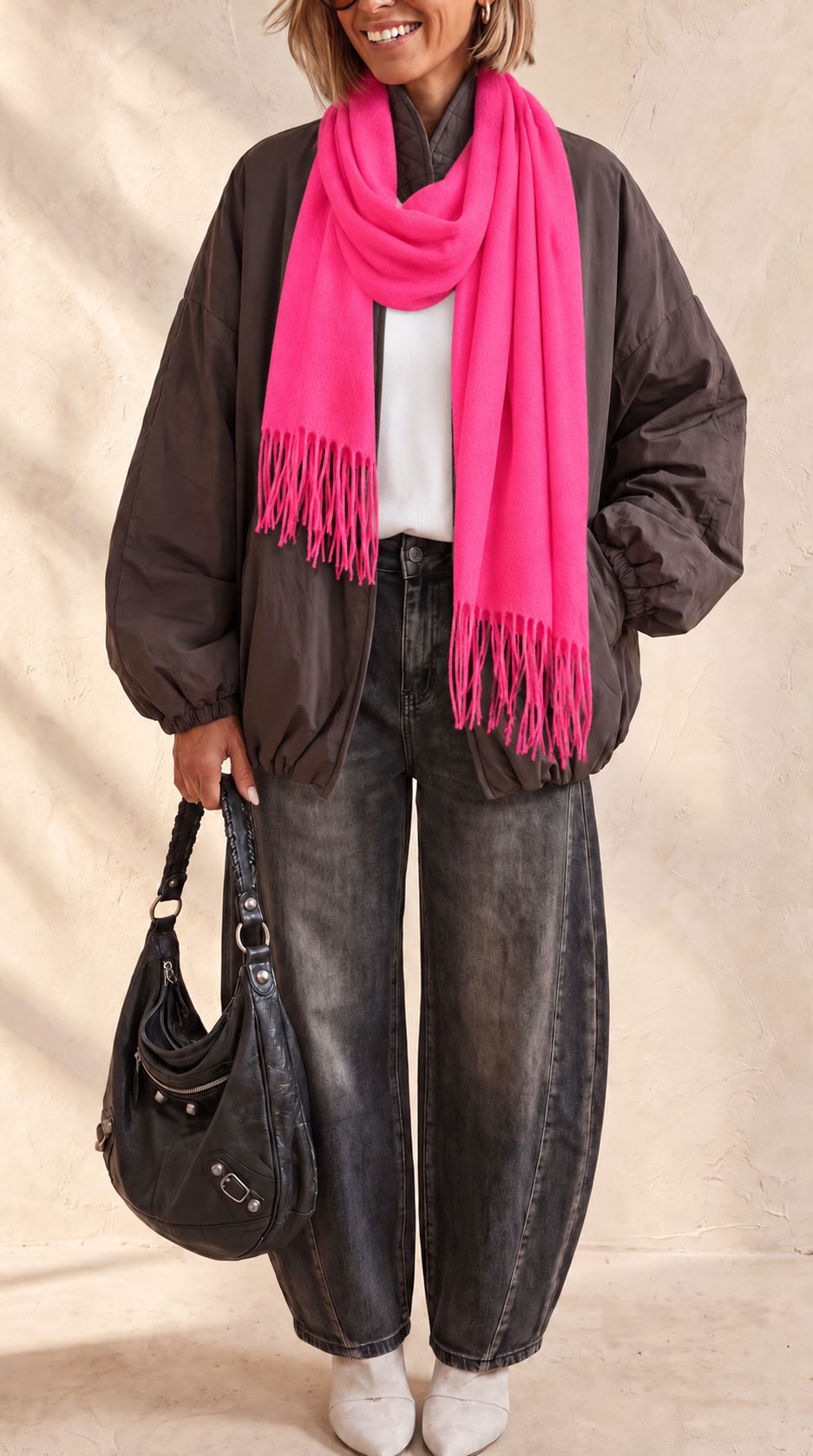 The Aspen Scarf in bright fuchsia with a soft cashmere blend, generous shape and classic fringed edges.

